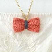 Crochet bow pendant. Coral pink and grey cotton yarn.